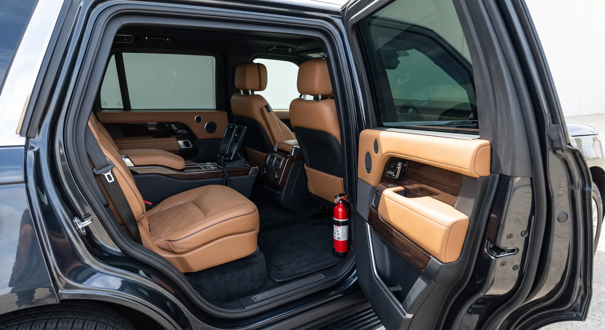 Discreet premium protected SUV cabin with reinforced door construction and secure communications